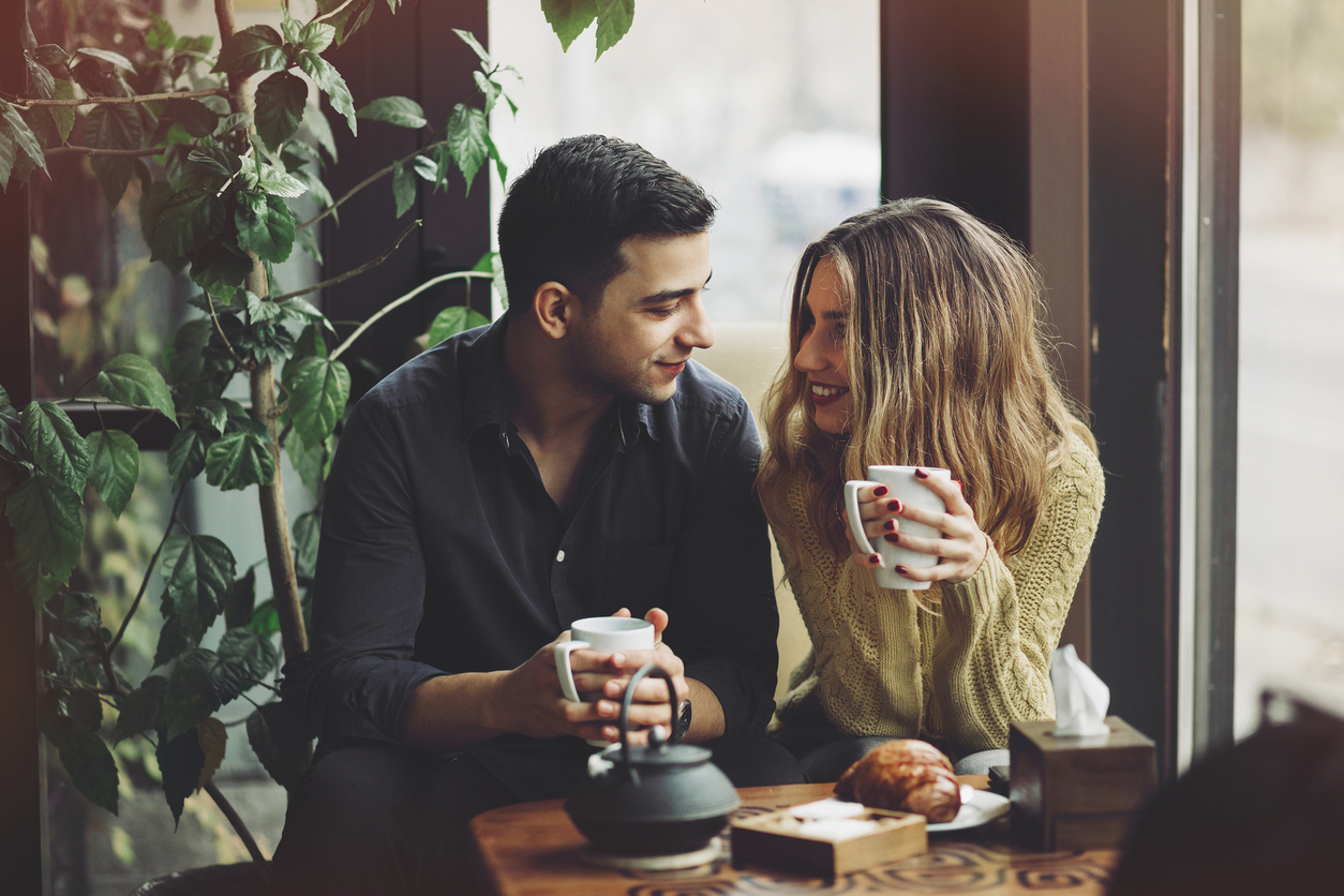 Couple in love drinking coffee and have fun in coffee shop. Love concepts. Vintage effect style picture