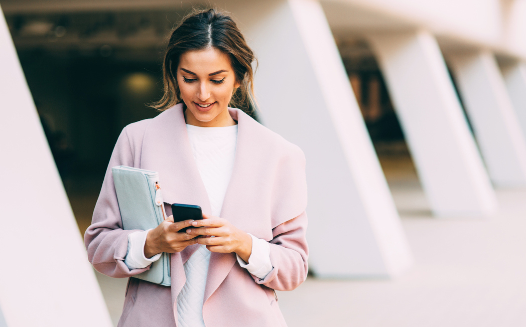 Beautiful elegant woman texting on the phone